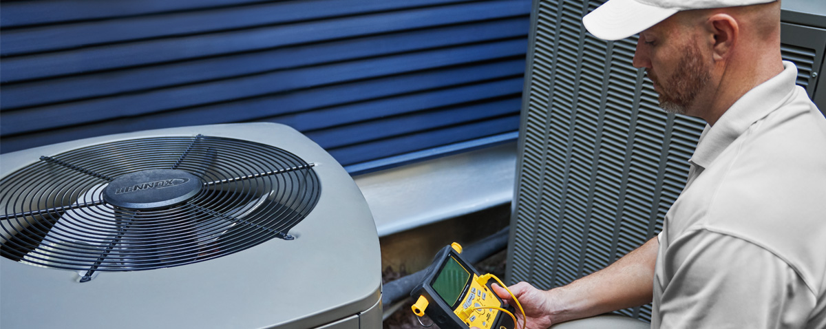 Technician inspecting outdoor AC unit