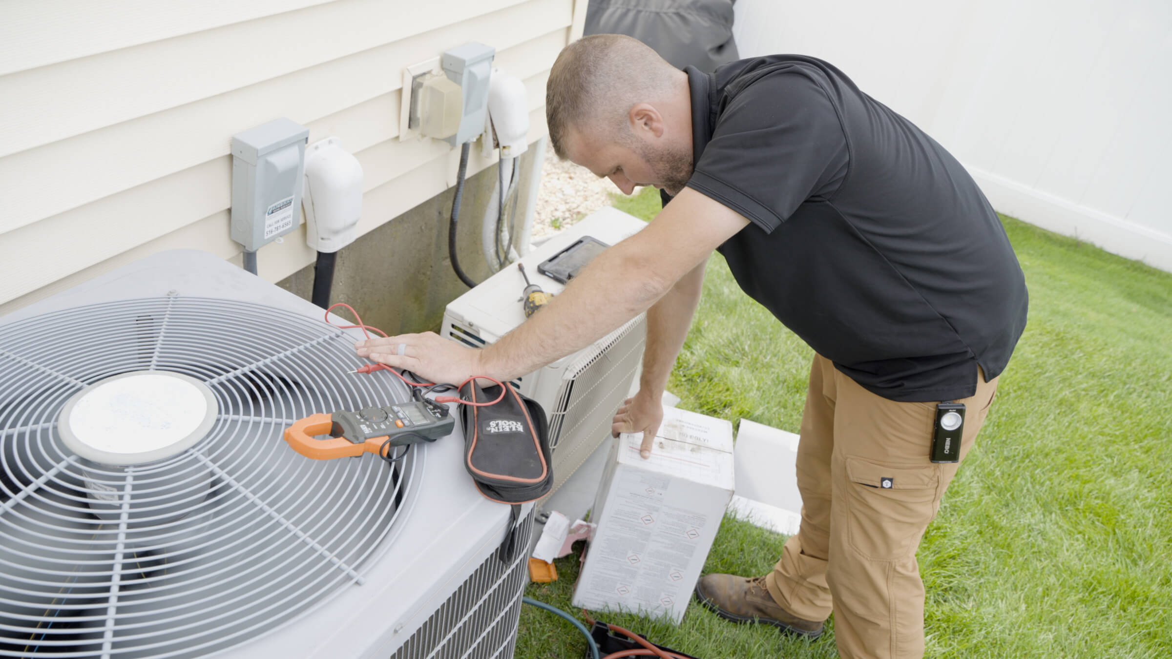 HVAC service technician working on outdoor unit